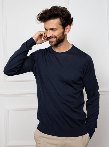 Man wearing midnight blue/grey long sleeved knit in 100% merino wool from New Zealand.